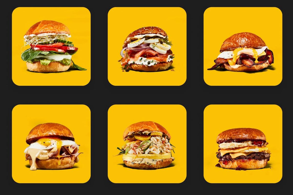 A variety of egg sandwiches on yellow squares that are on a black background.
