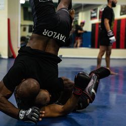 Louis Taylor flips his body before pinning his opponent down during a training session at Chicago Fight Team MMA on Chicago’s south side. | Annie Costabile/Sun-Times