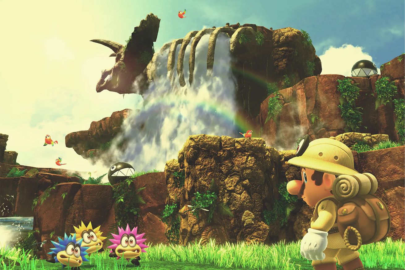 An image of Mario standing in front of dinosaur bones and a waterfall wearing attire for a safari.
