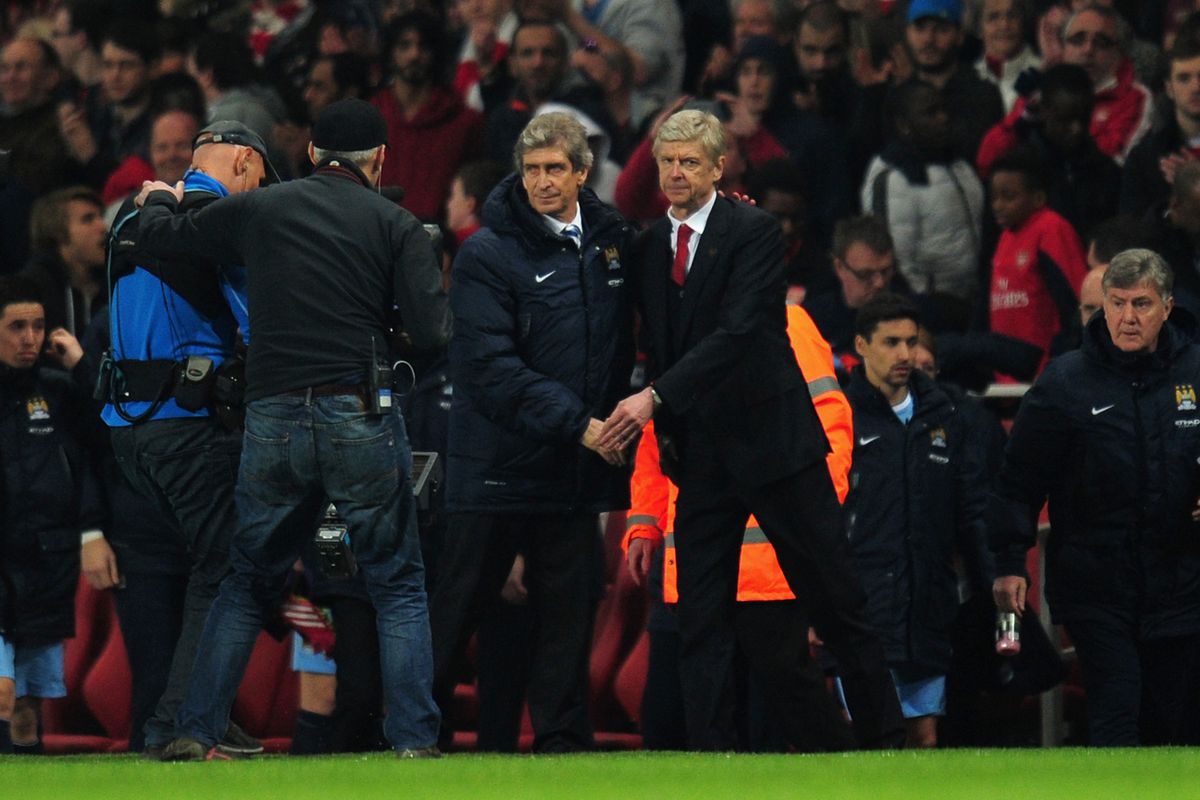 Pellegrini and Wenger share a moment after honors even at The Emirates.