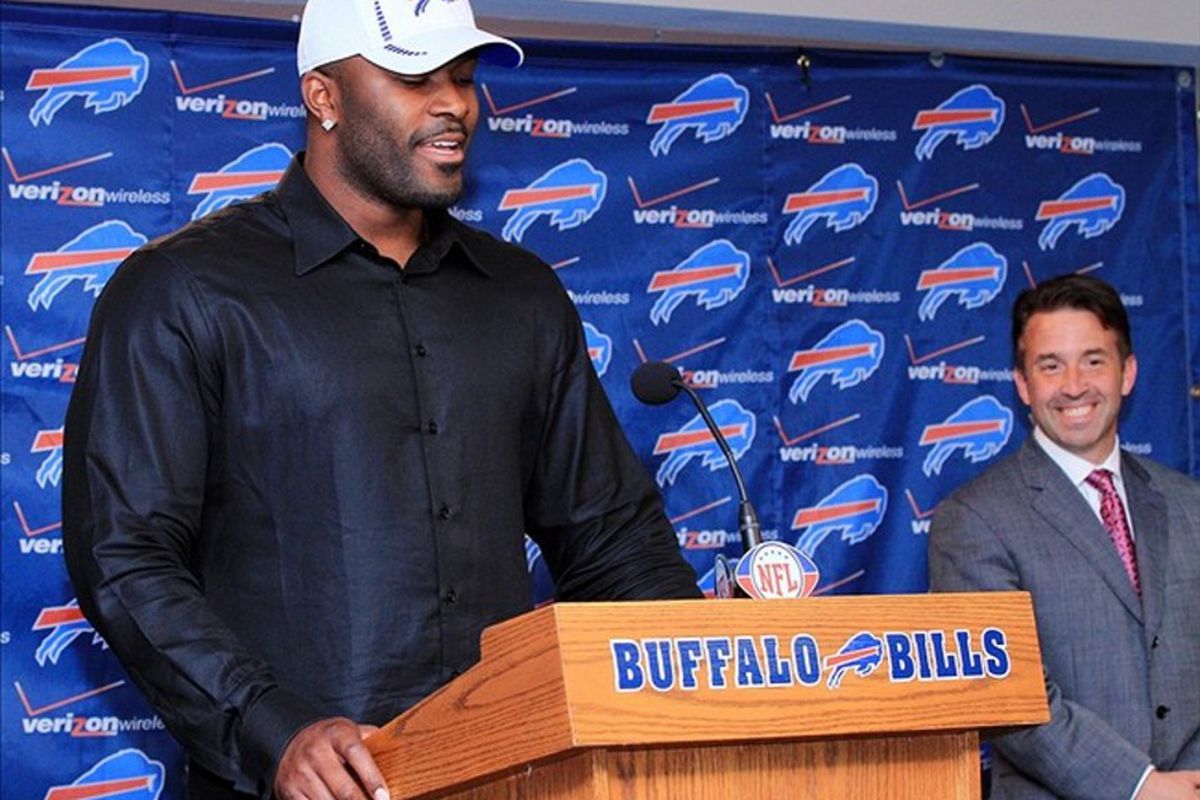 Mar 15, 2012; Orchard Park, NY, USA; Buffalo Bills new defensive end Mario Williams speaks at a press conference at Ralph Wilson Stadium. Chief executive officer Russ Brandon is seen in the background. Mandatory Credit: Kevin Hoffman-US PRESSWIRE
