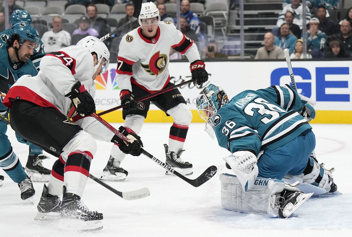 Goalie Kaapo Kahkonen #36 of the San Jose Sharks saves a glove hand from a shot by Tyler Motte #14 of the Ottawa Senators during the first period of an NHL hockey game at the SAP Center on November 21, 2022 in San Jose, California.