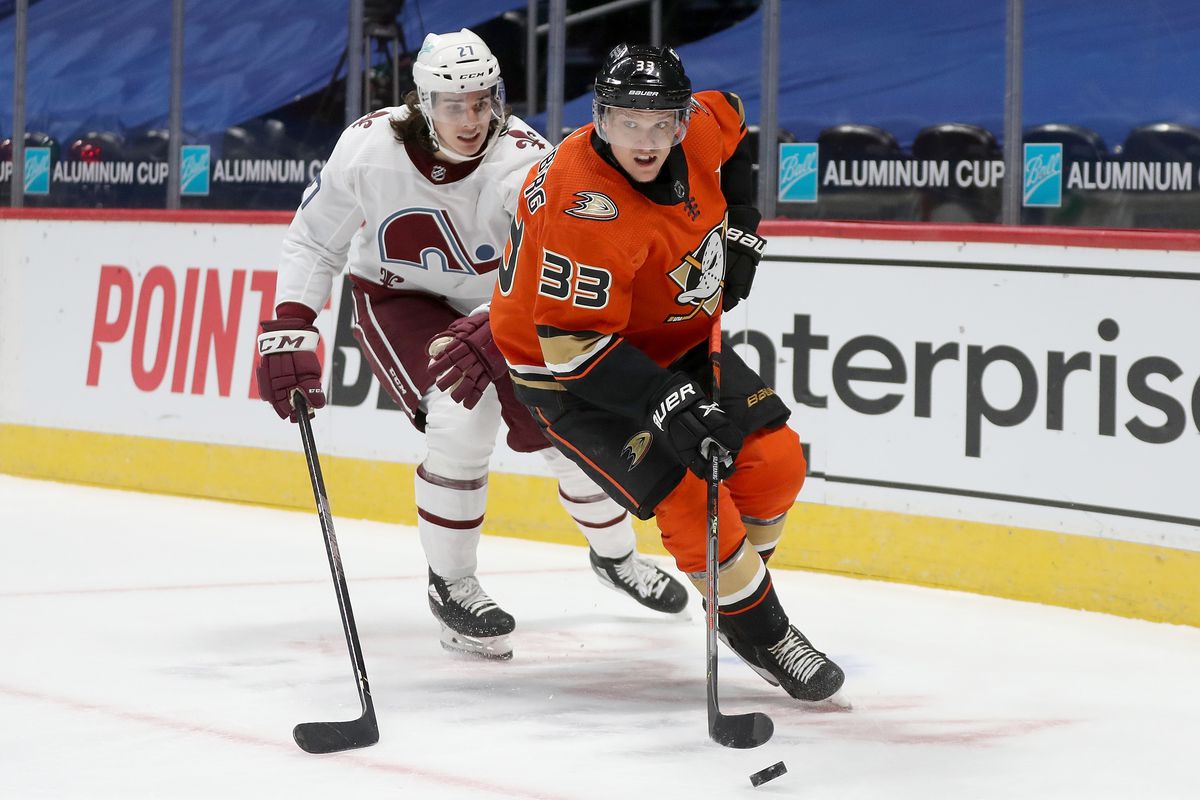 Jakob Silfverberg #33 of the Anaheim Ducks brings the puck off the boards against Ryan Graves #27 of the Colorado Avalanche in the first period at Ball Arena on March 06, 2021 in Denver, Colorado.