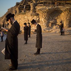 Ultra-Orthodox Jewish men of the Vizhnitz Hassidic sect pray on the Mediterranean Sea as they participate in a Tashlich ceremony in Herzeliya, Israel, Thursday, Sept. 28, 2017. Tashlich, which means "to cast away" in Hebrew, is the practice in which Jews go to a large flowing body of water and symbolically "throw away" their sins by throwing a piece of bread, or similar food, into the water before the Jewish holiday of Yom Kippur, which starts at sundown Friday. (AP Photo/Ariel Schalit)