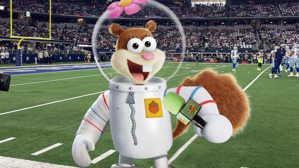 An image of Sandy Cheeks doing live commentary from the sidelines in the Nickelodeon stream of the Super Bowl. 
