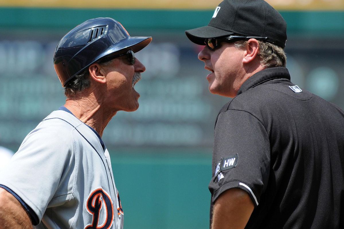 May 24, 2012; Cleveland, OH, USA: Detroit Tigers first base coach Tom Brookens (61) argues with umpire Paul Emmel (50) after being ejected during the game against the Cleveland Indians at Progressive Field.  Mandatory Credit: Eric P. Mull-USPRESSWIRE