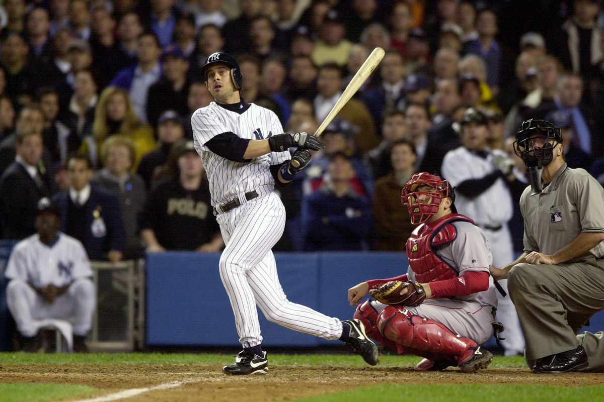 New York Yankees’ Aaron Boone hits a solo home run in the 11