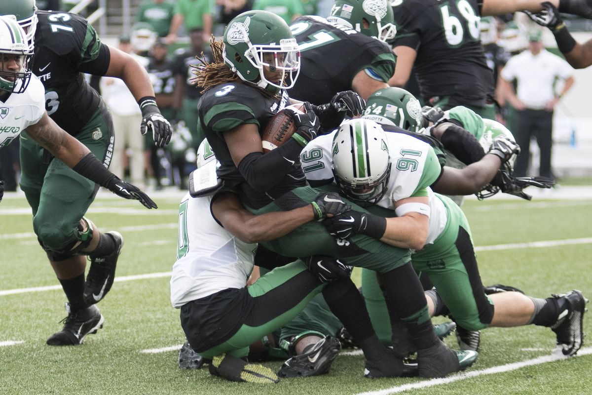 Marshall's Ryan Bee (91) wraps up Charlotte's Kalif Phillips (3) for a loss.