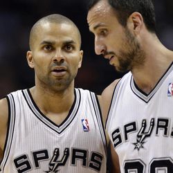 San Antonio Spurs' Tony Parker, left, of France, talks to Spurs' Manu Ginobili, of Argentina, during the first half of an NBA basketball game against the Utah Jazz, Friday, March 22, 2013, in San Antonio. 