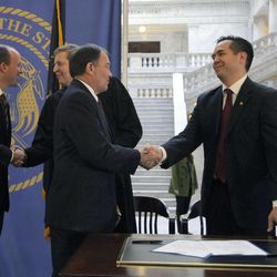 Sean Reyes shakes hands with Gov. Gary Herbert after signing the official papers following the oath of office as Utah's attorney general in the rotunda of the state Capitol in Salt Lake City on Monday, Dec. 30, 2013. Reyes replaces John Swallow, who resigned in November.