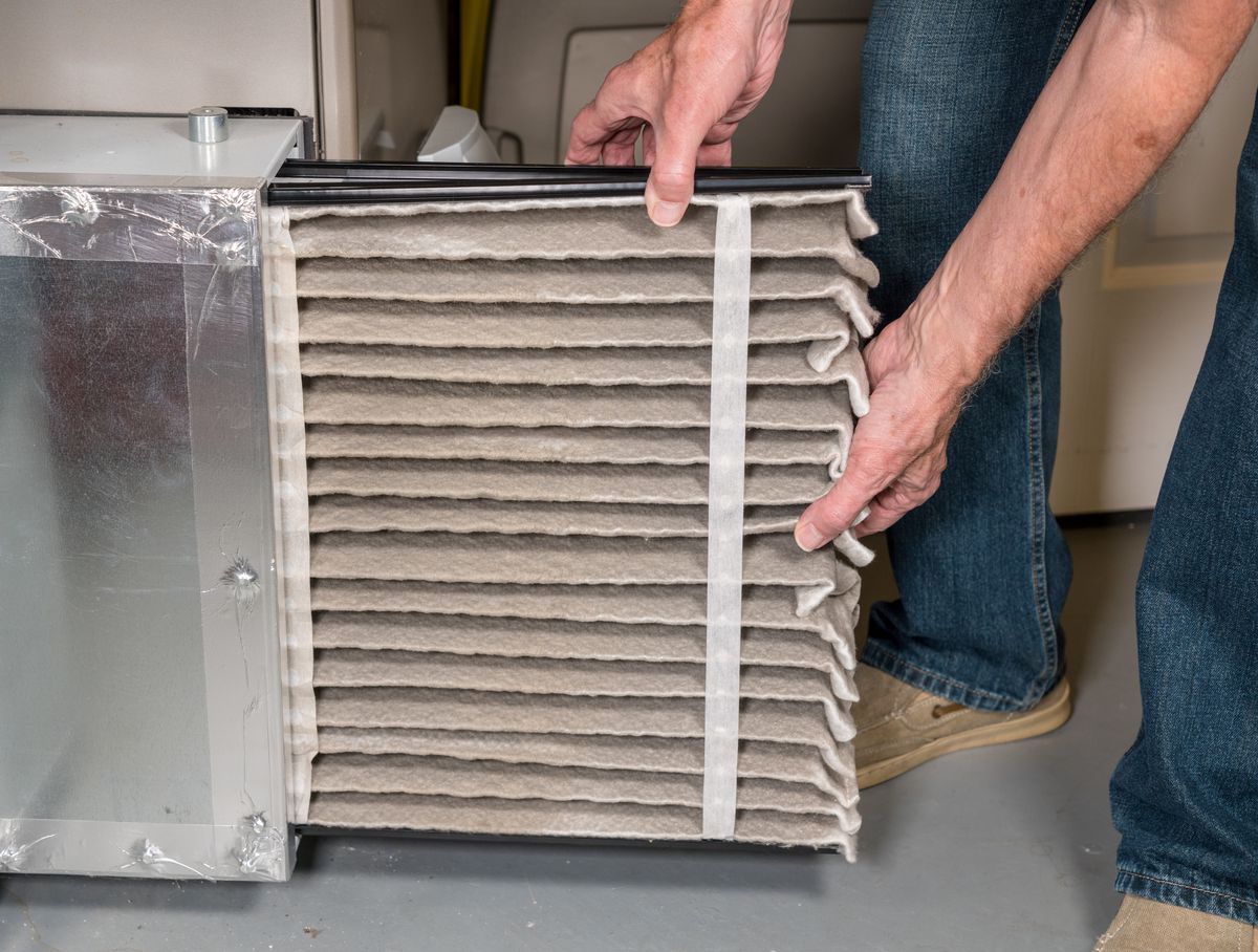 Man replacing air filter