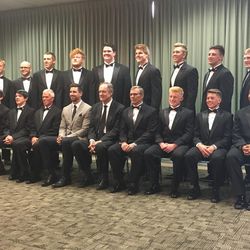 The 14 scholar-leader-athlete recipients pose for a photo with former BYU tight end and current Baltimore Raven Dennis Pitta and former BYU tight end and current NFL Network analyst Brian Billick prior to the 23nd annual banquet for the Utah Chapter of the National Football Foundation on Wednesday, April 12, 2017, at UVU’s UCCU Center.