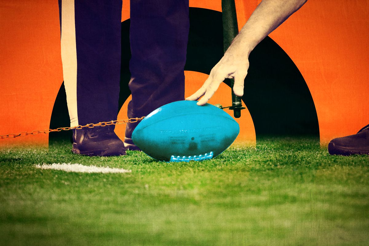 A hand of an official marking a football