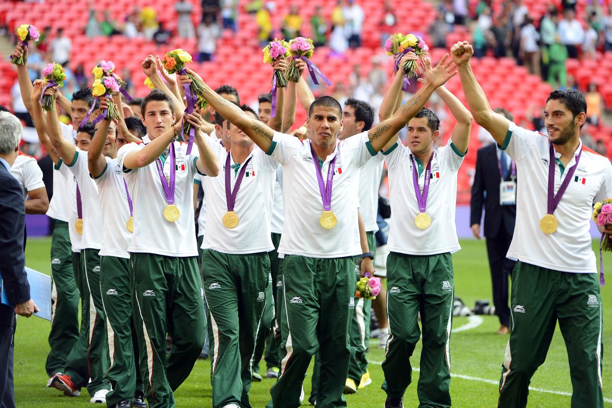 Mexico players take a victory lap with their gold medals after defeating Brazil 2-1 during the men's soccer gold medal match in the 2012 London Olympic Games at Wembley Stadium.  (Christopher Hanewinckel-USA TODAY Sports)