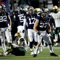 Brigham Young Cougars linebacker Ben Bywater (33) celebrates after tackling UAB Blazers running back DeWayne McBride (22) as BYU and UAB play in the Radiance Technologies Independence Bowl in Shreveport, Louisiana, on Saturday, Dec. 18, 2021. UAB won 31-28.