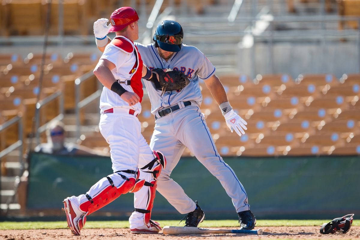 Cardinals prospect and Desert Dogs catcher Carson Kelly tags out Tim Tebow during the Arizona Fall League opener on Tuesday afternoon.
