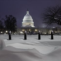 The Capitol is seen at twilight at the end of a record snowfall, Wednesday in Washington.  