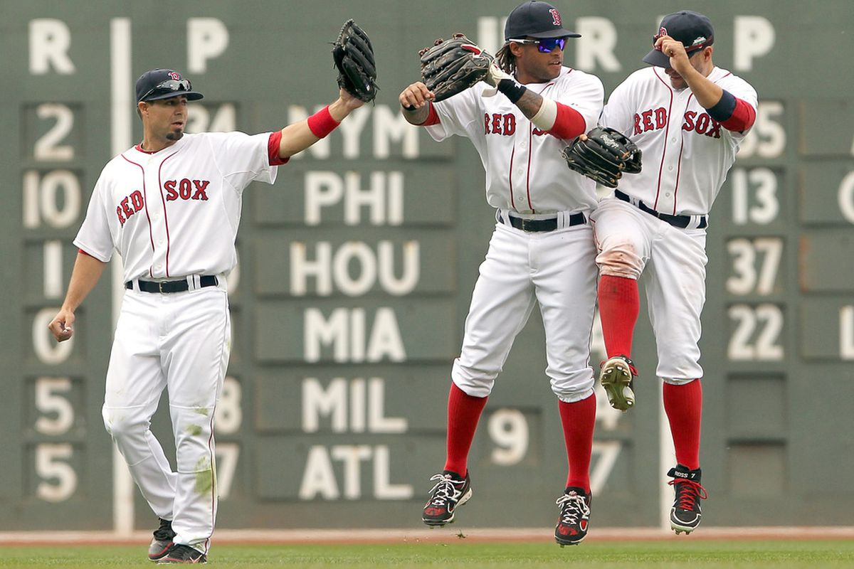 BOSTON, MA - Jason Repki, Darnell McDonald and Cody Ross of the Boston Red Sox celebrate their 6-4 win over the Tampa Bay Rays at Fenway Park in Boston, Massachusetts. (Photo by Jim Rogash/Getty Images)