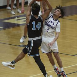 Tooele’s Justic Tadifa gets called for a foul as he blocks the shot of Canyon View’s Jake Tom during the first round of the 4A basketball tournament at Tooele High School on Tuesday, Feb. 23, 2021.