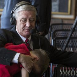 University of Utah athletic director Chris Hill receives a hug from his grandson, Jack Forsyth, 7, following a press conference regarding his retirement after 31 years in the position at Jon M. Huntsman Center in Salt Lake City on Monday, March 26, 2018. Hill was 37 years old when he took the position in 1987.