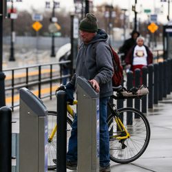 Steven Gaisford, of Lehi, uses an electronic card reader before boarding a FrontRunner train at the Utah Transit Authority's Salt Lake Central Station on Tuesday, Dec. 6, 2016.