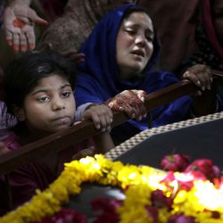A Pakistani Christian family mourn the death of Sharmoon who was killed in a bombing attack, in Lahore, Pakistan, Monday, March 28, 2016. The death toll from a massive suicide bombing targeting Christians gathered on Easter in the eastern Pakistani city of Lahore rose on Monday as the country started observing a three-day mourning period following the attack. 