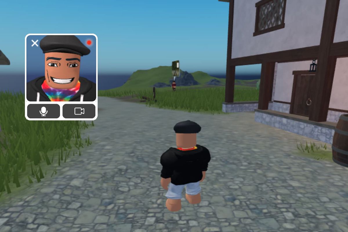 An image showing a demo of the new face-tracking feature from Roblox. It shows a Roblox character in an empty 3D environment. A window in the upper left-hand corner of the image shows the front face of the avatar.