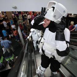 Brittanie Larsen, dressed as a stormtrooper from Star Wars, makes faces while riding the escalator at Utah's first Comic Con at the Salt Palace Convention Center in Salt Lake City on Thursday, Sept. 5, 2013.