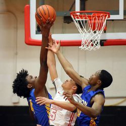 Homewood-Flossmoor’s Trace Williams (5) battles Simeon’s Sincere Callwood (4) and Frederick Poole (10) for the rebound in their 58-43 loss in Blue Island Friday, March 8, 2019. | Kevin Tanaka/For the Sun Times