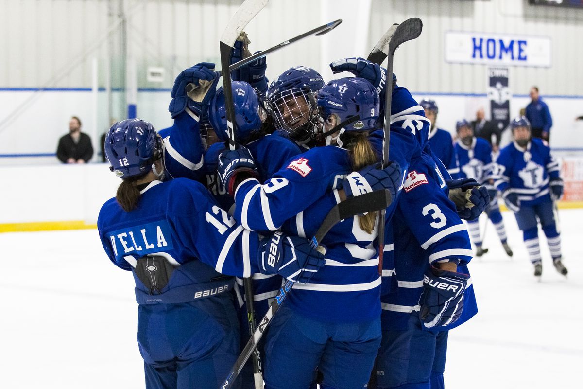 A group of Toronto Furies players hug in celebration of a win.
