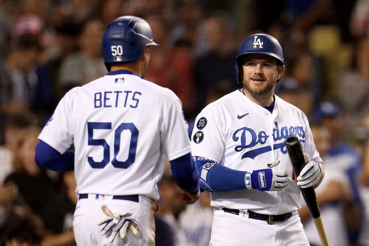 Max Muncy of the Los Angeles Dodgers reacts to the run of Mookie Betts, from a Will Smith single, to take a 5-0 lead over the Colorado Rockies, during the fourth inning at Dodger Stadium on September 30, 2022 in Los Angeles, California.