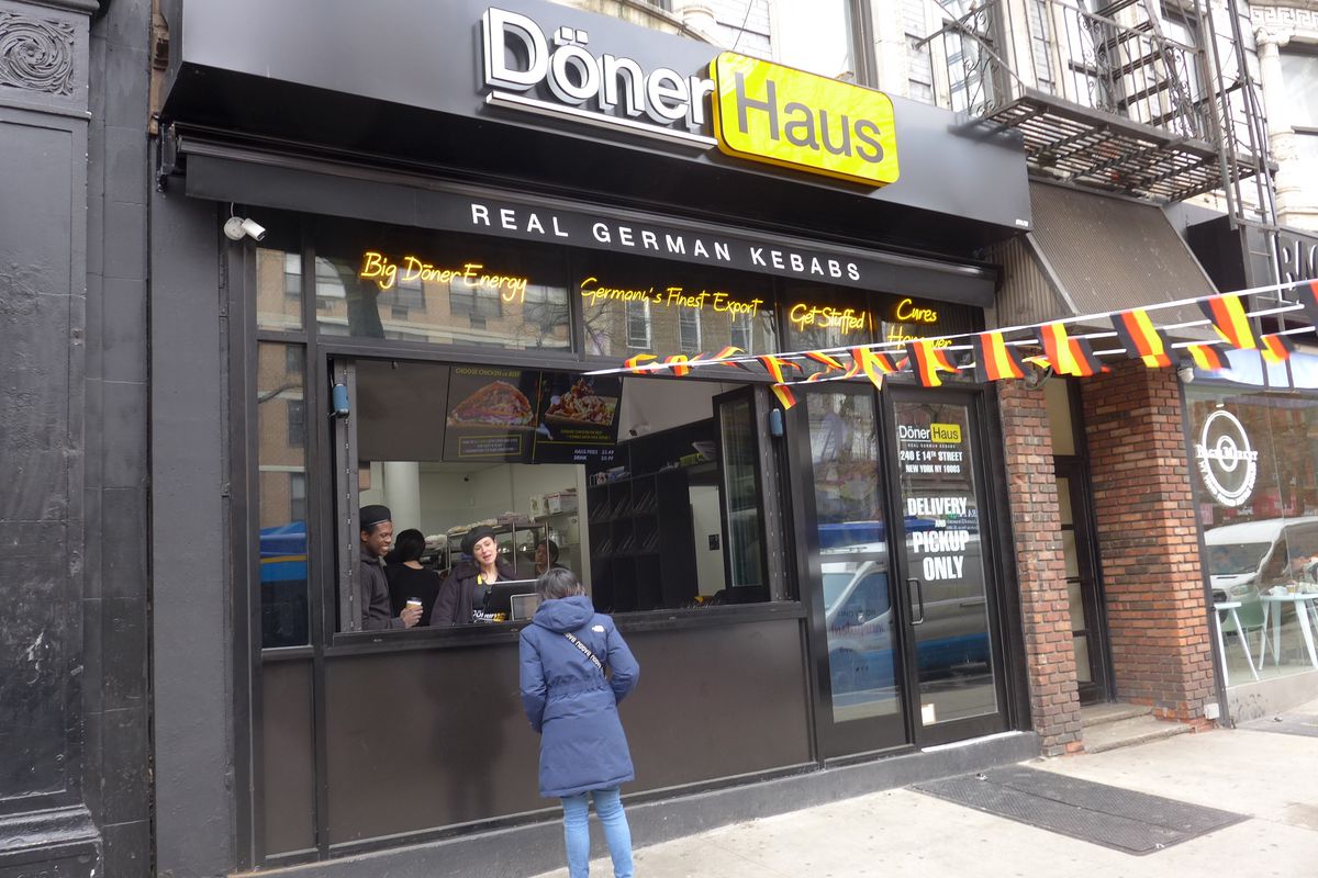 A person stands at the counter of Döner Haus, a restaurant in the East Village specializing in doner kebab.