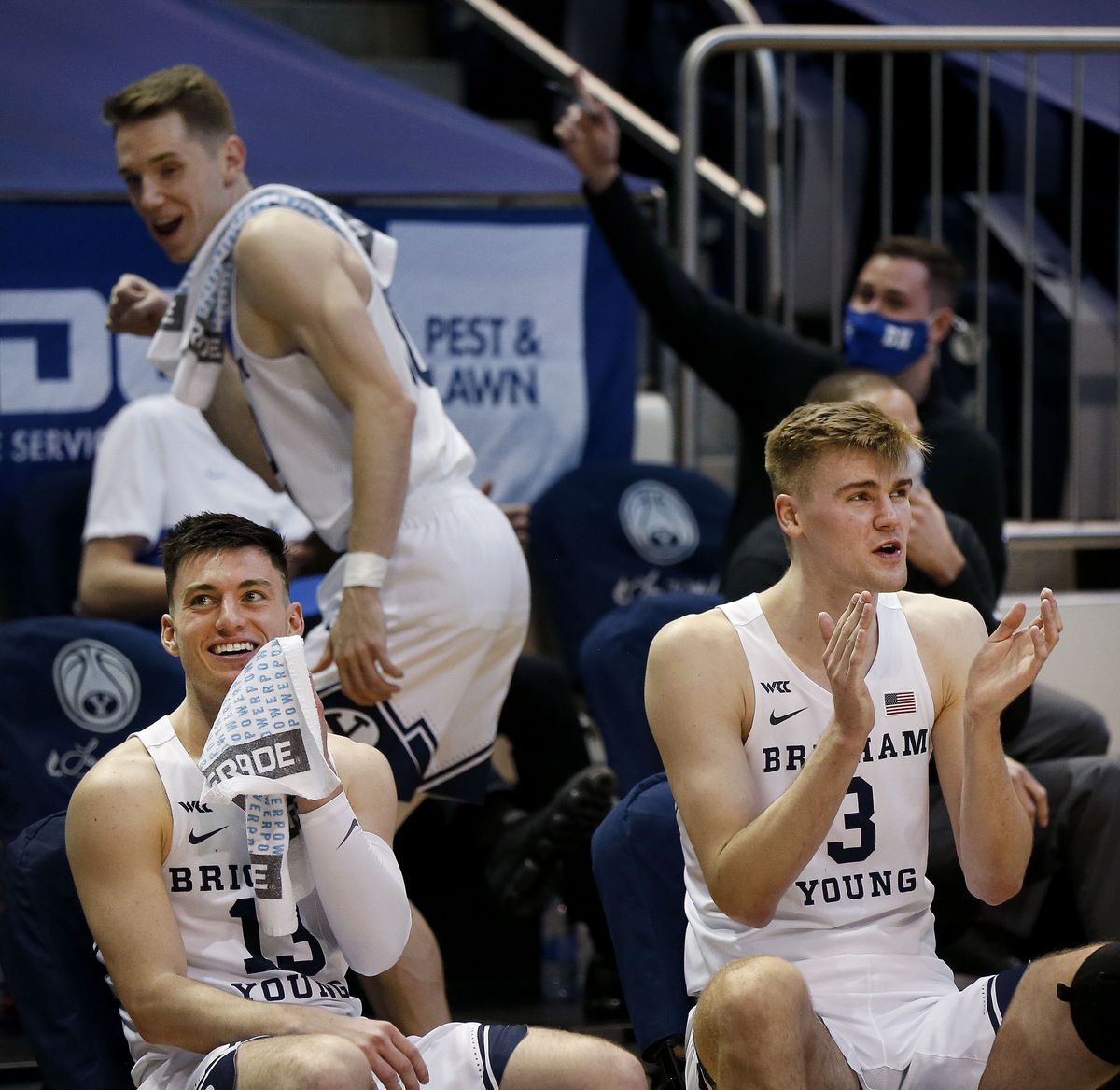 Brigham Young Cougars guard Alex Barcello (13) and Matt Haarms (3) make jokes from the bench as their teammates play against Portland at the Marriott Center in Provo on Thursday, Jan. 21, 2021.