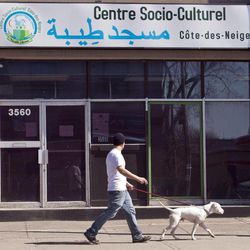 A man walks his dog past a mosque where Chiheb Esseghaier, one of the two accused in an alleged plot to bomb a Via passenger train, used to attend Tuesday, April 23, 2013 in Montreal. Canadian investigators say Raed Jaser, 35, and his suspected accomplice Chiheb Esseghaier, 30, received "directions and guidance" from members of al-Qaida in Iran. Iran said it had nothing to do with the plot, and groups such as al-Qaida do not share Iran's ideology. 