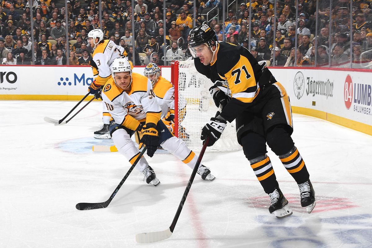 Evgeni Malkin #71 of the Pittsburgh Penguins handles the puck against Mark Borowiecki #90 of the Nashville Predators at PPG PAINTS Arena on April 10, 2022 in Pittsburgh, Pennsylvania.