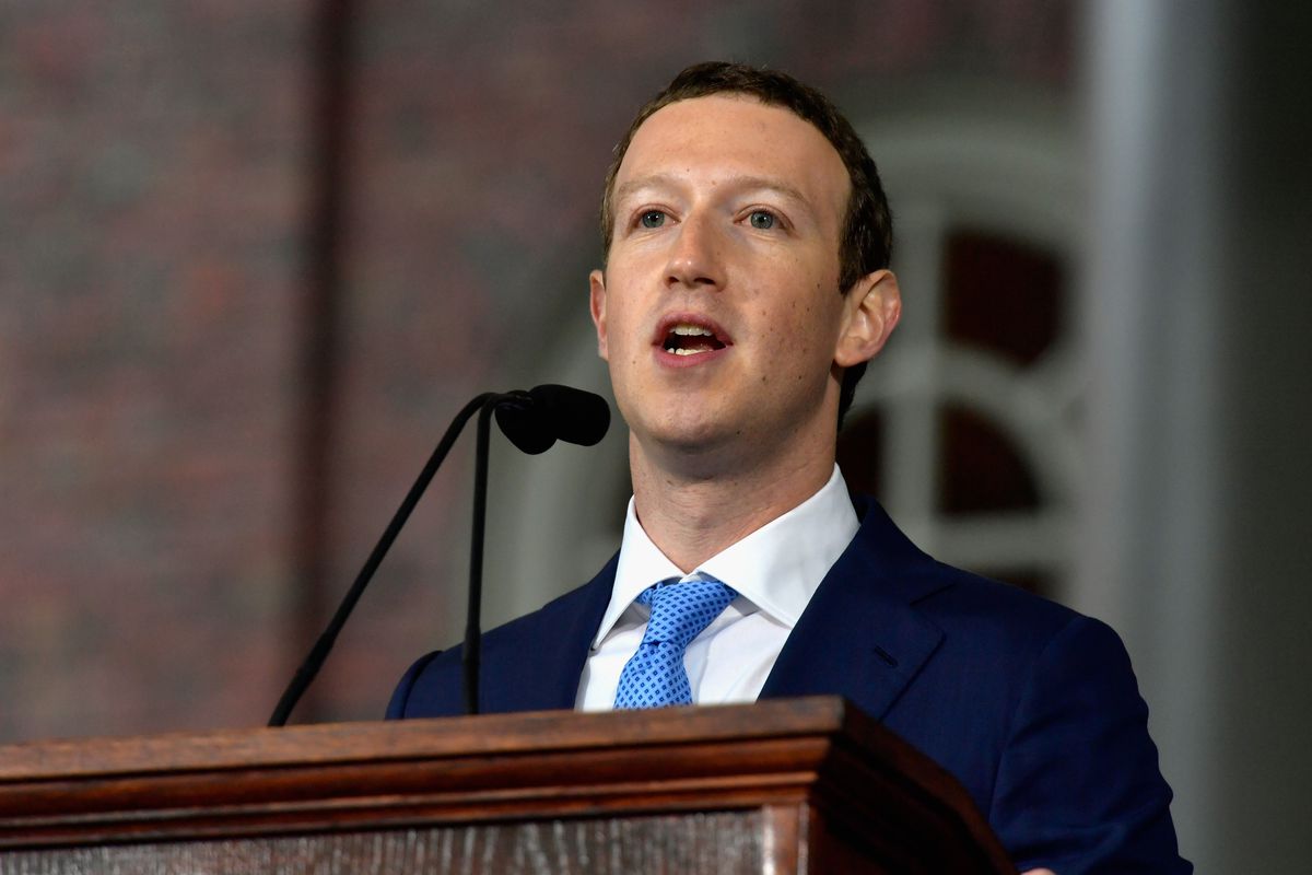 Facebook founder Mark Zuckerberg speaks behind a podium and microphone at Harvard’s commencement.