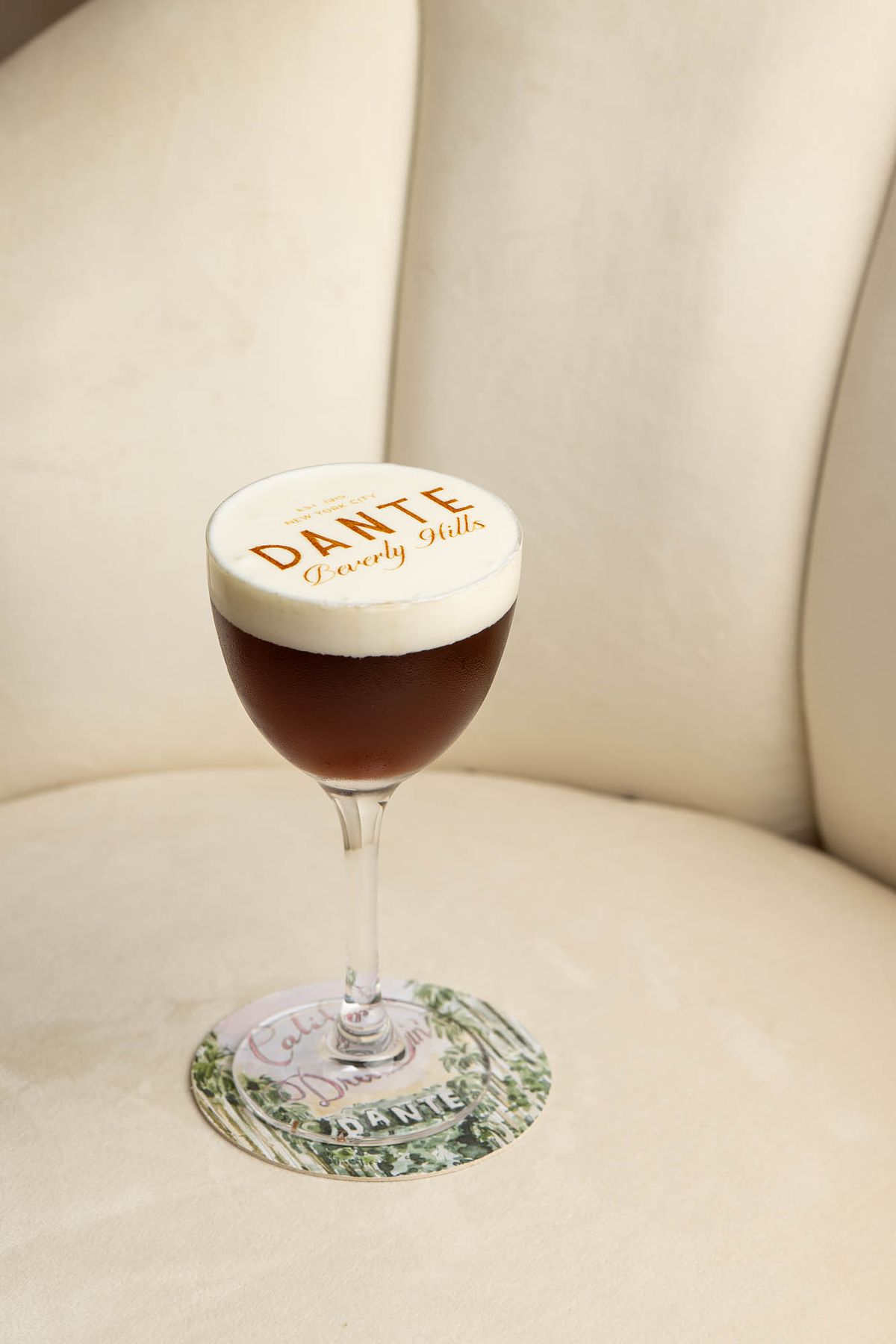 An espresso martini on a white couch at Dante Beverly Hills.