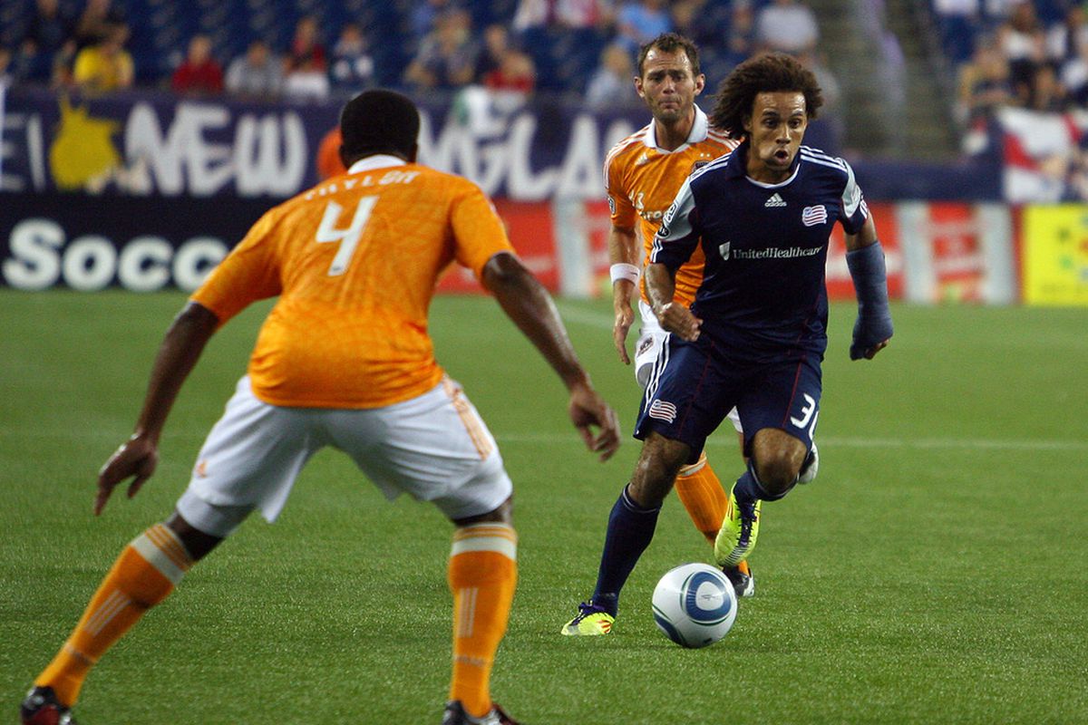 FOXBORO, MA - AUGUST 17:   Kevin Alston #30 of the New England Revolution squeezes by the Houston Dynamo defense at Gillette Stadium August 17, 2011 in Foxboro, Massachusetts. (Photo by Gail Oskin/Getty Images)