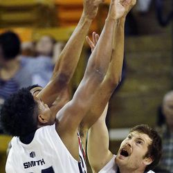 Chris Smith (34) and David Collette (13) of Utah State reach for a rebound against a UNLV player during NCAA basketball in Logan Tuesday, Feb. 24, 2015.

