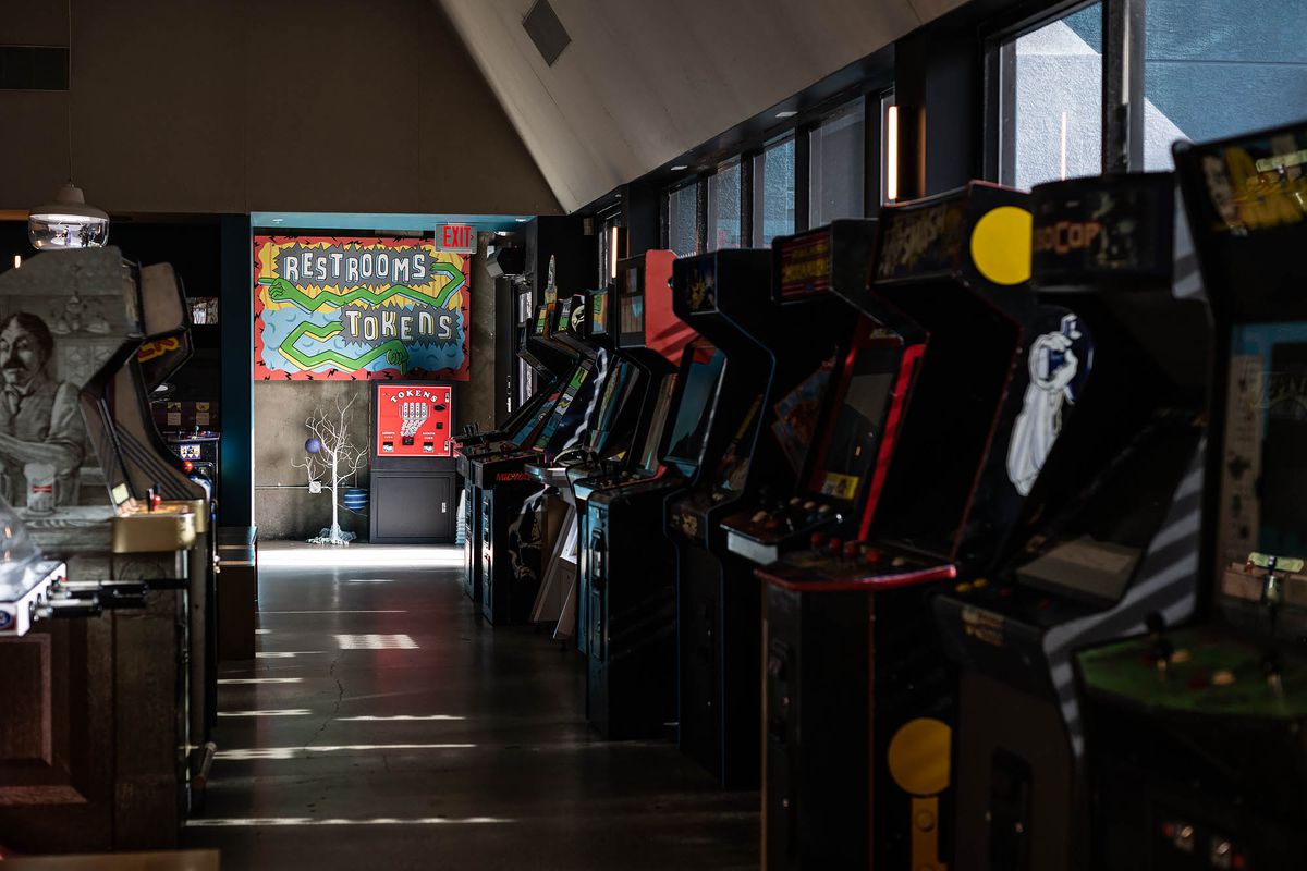 A darkened arcade before service.
