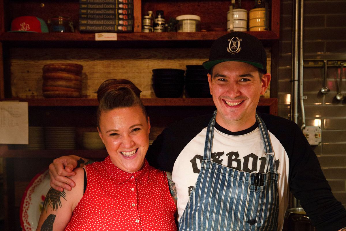 Thomas and Mariah Pisha-Duffly stand next to each other in a pop-up kitchen.