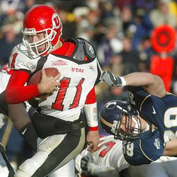 BYU's Bryant Atkinson is unable to hold on for a quarterback sack of Utah's Alex Smith on Nov. 22, 2003. Utah won the game, 3-0.
