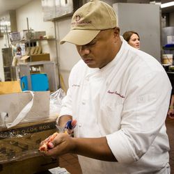 Chef Ronnie Rainwater, of Delmonico Steakhouse in La Vegas, preps king crab legs in the kitchen at The Hyatt Regency.