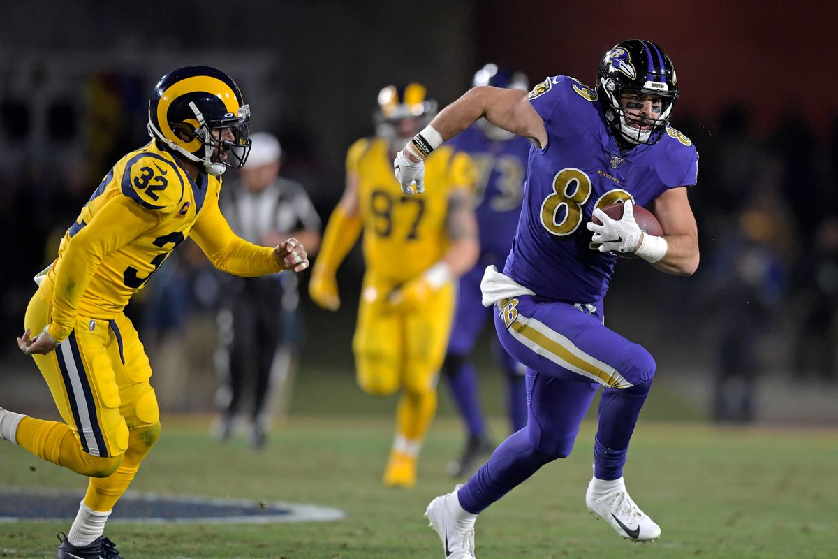 Baltimore Ravens tight end Mark Andrews carries the ball past Los Angeles Rams free safety Eric Weddle during the second half at Los Angeles Memorial Coliseum.