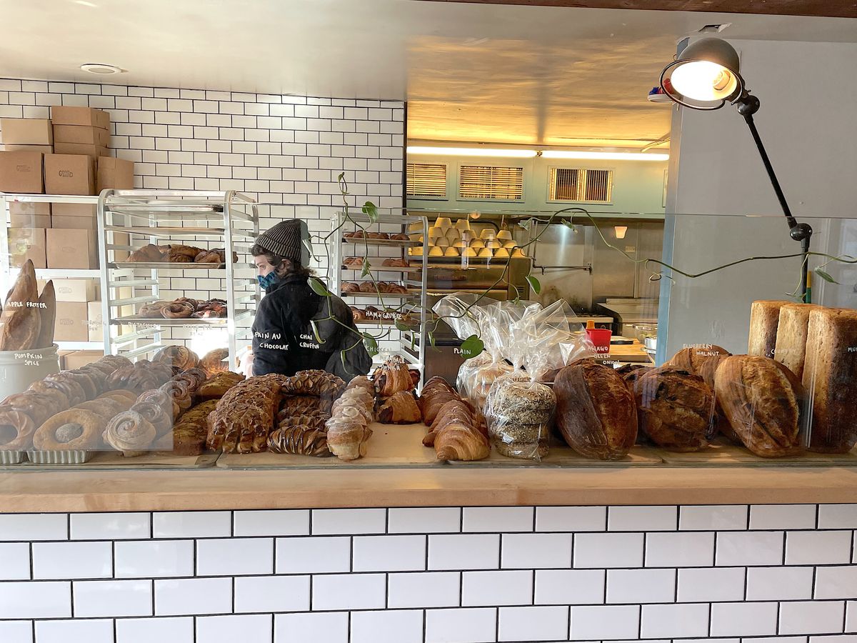 Bakery counter lined with breads and pastries