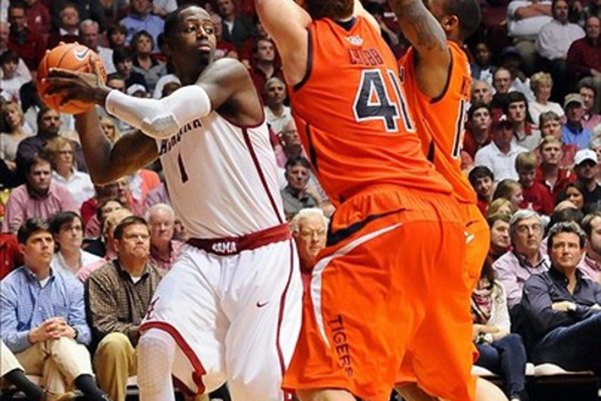 Auburn played great defense last night against Alabama but still lost another road game. Above JaMychal Green (1) looks to pass around Auburn Tigers guard Tony Neysmith (15) and center Rob Chubb (41) Feb. 29th in Coleman Coliseum.  Alabama won 55-49.