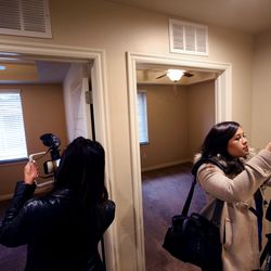 Reporters photograph a two-bedroom apartment at the launch of the Shared Housing Program at Taylor Gardens Apartments in Salt Lake City on Thursday, March 21, 2019. The program is designed to house 50 individuals experiencing homelessness by the end of 2019.