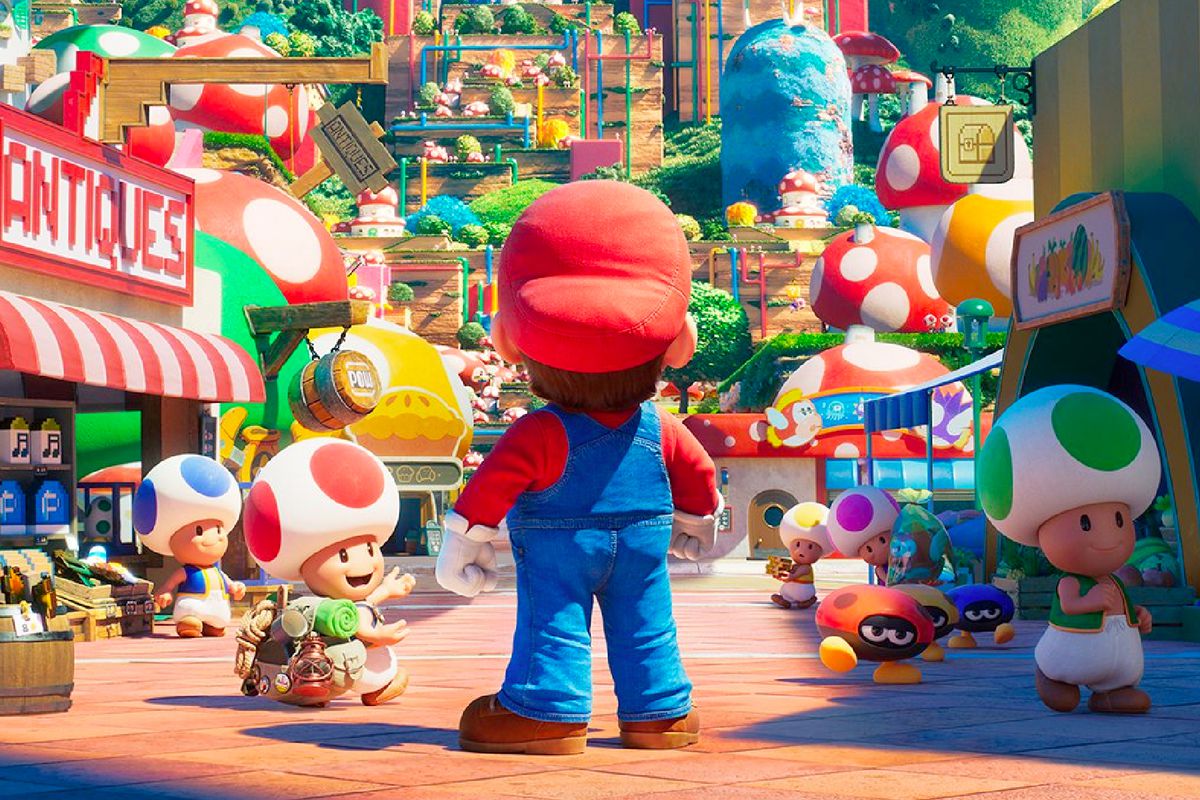 The back of Mario as he stands in a crowded shopping street populated by Toads in the Mushroom Kingdom
