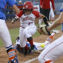 Nebraska's Gabby Banda runs home to score past Florida's Stephanie Tofft as she drops the ball in the seventh inning of their College Softball World Series at ASA Hall of Fame Stadium in Oklahoma City, Saturday. Florida won 9-8 after 15 tense innings.