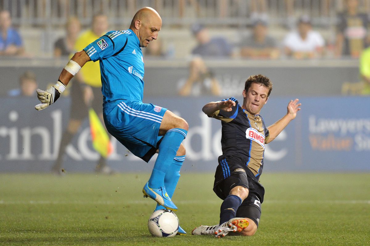 CHESTER, PA - JULY 29: Antoine Hoppenot #29 of the Philadelphia Union tries to steal the ball away from Matt Reis #1 of the New England Revolution at PPL Park on July 29, 2012 in Chester, Pennsylvania. (Photo by Drew Hallowell/Getty Images)